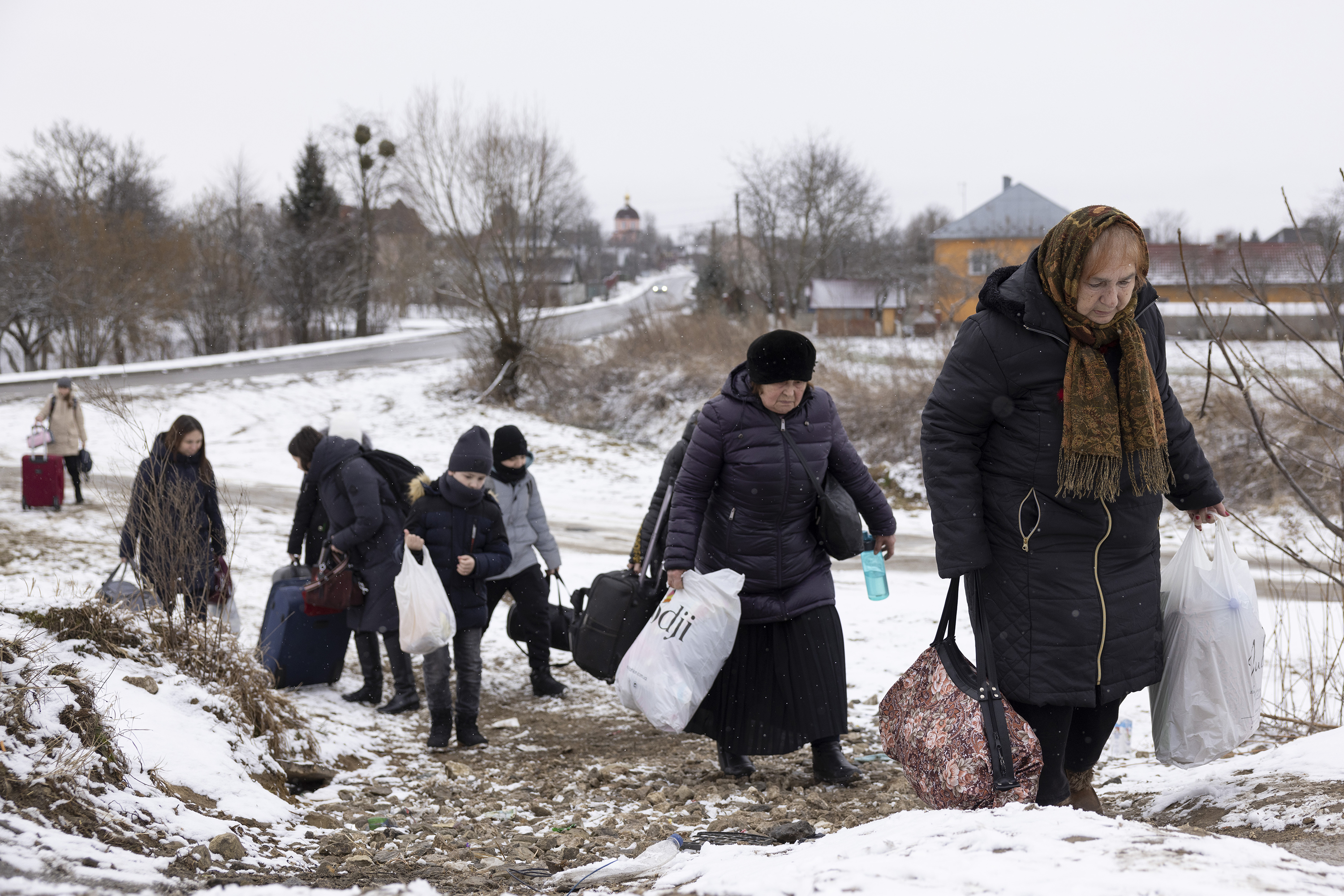 Refugees fleeing conflict make their way to the border crossing with Poland on March 9 in Krakovets, Ukraine. 