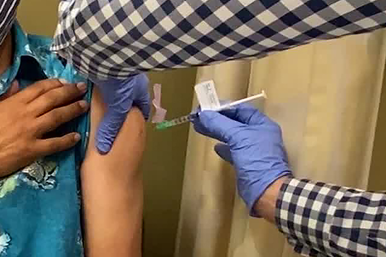 A man receives an injection as UCLA and AstraZeneca begin phase three trials in a potential COVID-19 vaccine. 