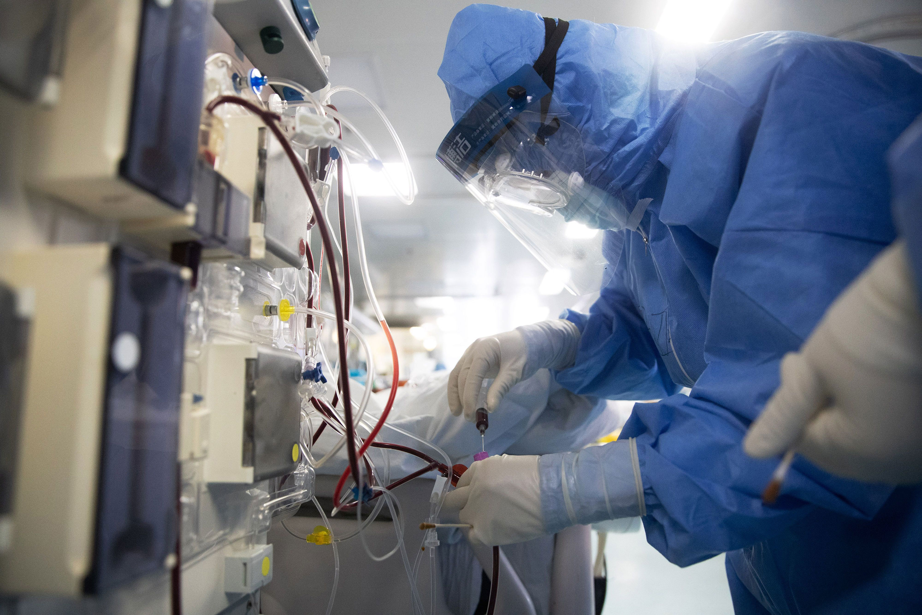 Medical staff check equipment as they treat coronavirus patients at a hospital in Wuhan on March 19.