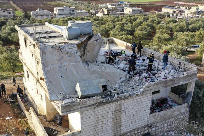 People inspect a destroyed house following an operation by the U.S. military in the Syrian village of Atmeh, in Idlib province, Syria, Thursday, Feb. 3, 2022. U.S. special operations forces conducted a large-scale counterterrorism raid in northwestern Syria overnight Thursday, in what the Pentagon said was a successful mission. Residents and activists reported multiple deaths including civilians from the attack. (AP Photo/Ghaith Alsayed)