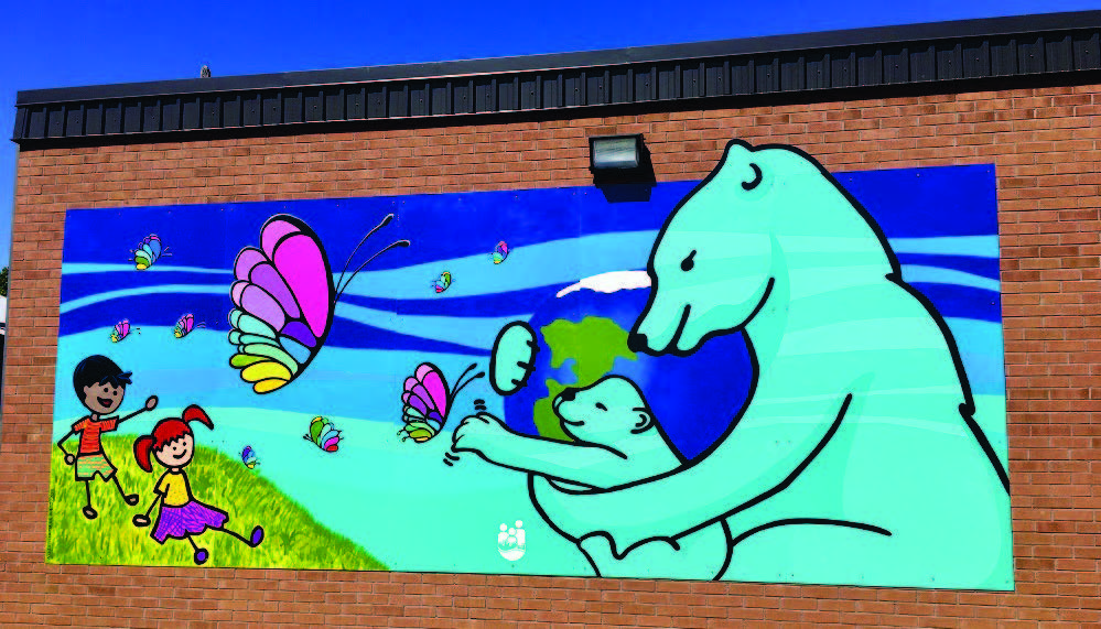 Mural featuring polar bears, butterflies and children