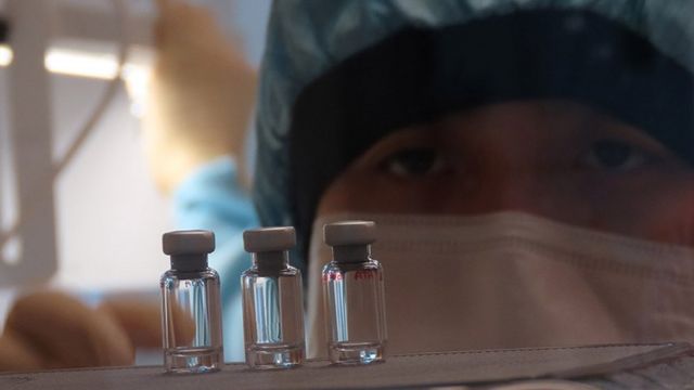 Person and some vials Person and some vials